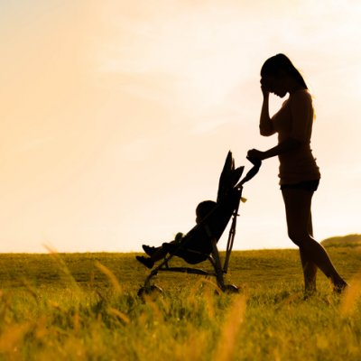 A silhouette of a mum with a baby in a pram.